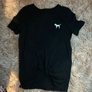 A black and white shirt the has a knock tie in the center very cute